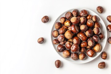 Obraz premium Top view of chestnuts on white plate, white background