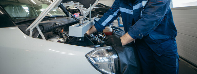 Car engine repair in a car workshop