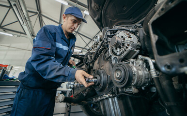 Auto mechanic repairs an engine. Replacing the timing chain