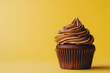 Delicious chocolate cupcake on a vibrant yellow background - sweet temptation for dessert lovers