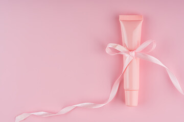 Elegant cosmetic package adorned with delicate ribbon