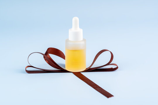 Elegant cosmetic dropper bottle with ribbon