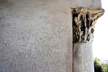 hooligan inscriptions and drawings on an old wall in Rome, Italy