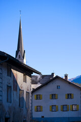 Scenic view of Swiss mountain village of Surava with traditional houses and church tower on a sunny autumn day. Photo taken November 15th, 2024, Surava Albula, Switzerland.