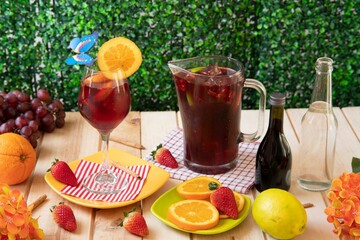 Fototapeta premium Glass of handmade summer wine next to bottle of wine