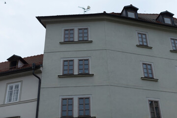 The image depicts a beautifully designed multistory residential building, highlighting its numerous...