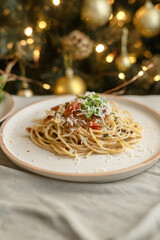 Festive pasta dish surrounded by Christmas decorations, capturing holiday vibes with lights, ornaments, and a cozy festive setting. Perfect for themes like Christmas food, holiday celebrations.