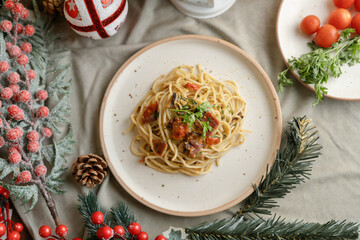 Festive pasta dish surrounded by Christmas decorations, capturing holiday vibes with lights, ornaments, and a cozy festive setting. Perfect for themes like Christmas food, holiday celebrations.