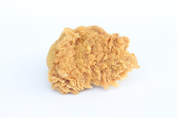 A piece of fried chicken is sitting on a white background. The chicken is golden brown and crispy, with a slightly charred flavor. Concept of indulgence and satisfaction