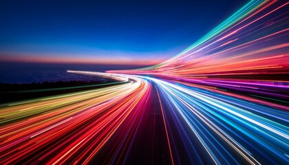 Vibrant streaks of light paint a dynamic highway scene at twilight.