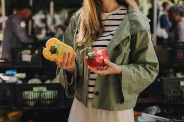 Woman on the market. Mature Female Customer Shopping At Farmers Market Stall. Woman shopping at the...