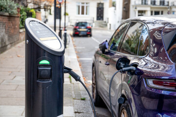 Charging an electric car on the street, greener energy vehicle