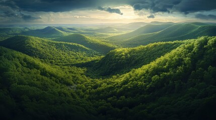 Obraz premium Stunning panorama of the Appalachian Trail showcasing lush greenery and distant mountains under a dramatic sky at sunset