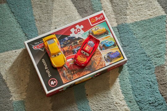 Closeup shot of the Mattel Cruz Ramirez and Lightning McQueen on a Trefl Disney Pixar Cars puzzle.