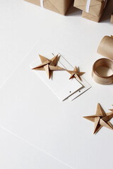 Holidays Presents Packaging and Decorating. Gift Tags, Decorative Origami Stars, Gift Boxes on White Background.