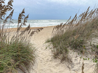 Path through sand dunes and waves on a stormy day, Outer Banks sand beach