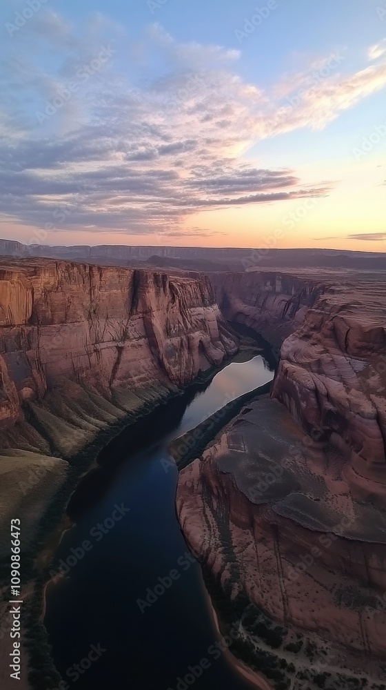 Poster a tranquil canyon view during twilight, capturing the river's gentle flow beneath colorful evening s