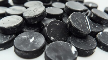 Pile of Used Hockey Pucks - Worn hockey pucks, sport equipment, ice hockey, competition, training.