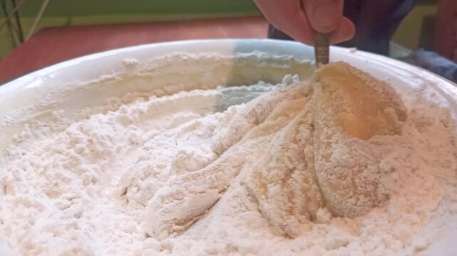  Proccess of making shortbread dough for a pie, mixing with spoon. Horizontal 4k footage. Baking