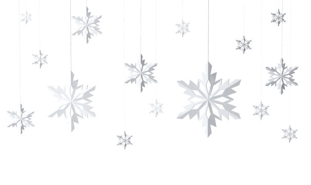 White paper snowflakes hang on strings in the air, on a white background. Simple and minimalist decoration concept with a winter season theme