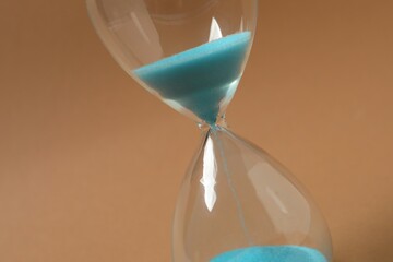 Modern hourglass on color background. Hourglass time concept for business deadline, urgency and...
