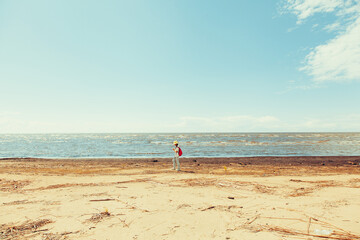 a man with a backpack is walking along the beach