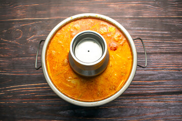 Tom Yum Soup served in broth isolated on wooden table top view of bangladeshi and thai food