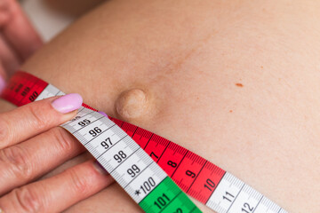 Doctor measuring a pregnant belly with a tape