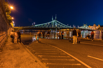 Budapest, Hungary - September 20, 2024: Spectators Gather to Watch Flooding Near Liberty Bridge in Budapest.