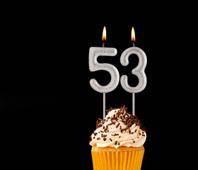 Number 53 shaped candles - Birthday cupcake on black background.