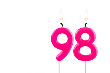 Pink number 98 birthday candle on white background