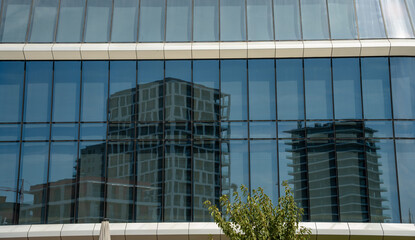 Fototapeta premium Budapest, Hungary - August 24, 2024: Contemporary architecture: skyscraper reflections in the glass of a new building.