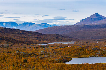 Autumn landscape of Kilpisjarvi, Finland, showcasing colorful foliage, serene lakes, and majestic...