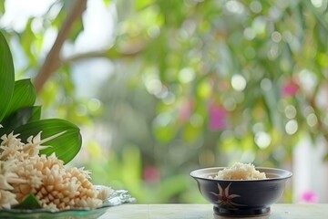 Fresh jasmine blossoms and rice bowl on table outdoors.