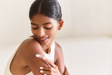 Skin Care Routine With Cream; Woman Smiling, Applying Lotion On Shoulder, Promoting Healthy,...