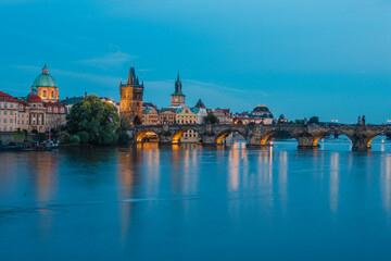 Fototapeta premium Karlův most - Charles Bridge (Arch bridge) in Prague, at dusk - sunset