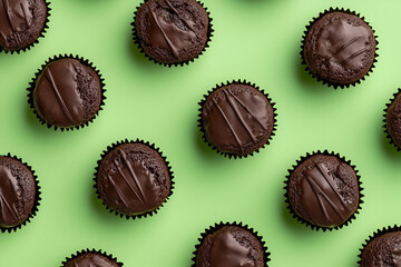 Baking delight chocolate cupcakes on a vibrant green background
