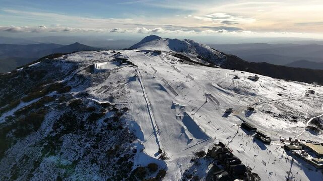 Aerial view of Mount Buller ski resort in winter, showing snow-covered mountain scenery and numerous skiers on the slopes