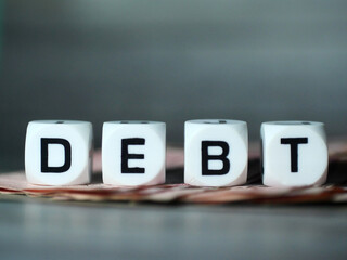 DEBT short word english letter or text in the concept of saving money and finance.Selection focus.