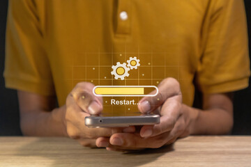 Man holding a smartphone with operating system being restarted or rebooted