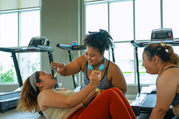 Obraz premium Plus size women workout at fitness center.