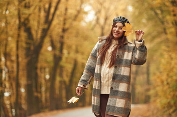 Positive facial expression. Happy woman is in the autumn forest