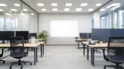 A modern office space featuring multiple workstations, large windows, and a projector screen, promoting a bright and collaborative environment.