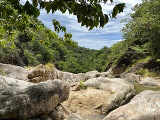 Tropical waterfall: Rocks, jungle and sky