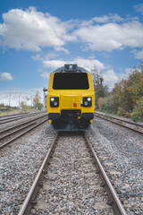 Obraz premium A front view of a Class 70 locomotive approaching on railway tracks