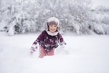 Little girl wearing a cozy winter outfit, happily exploring deep snow. The pure white snow surrounds her, creating a dreamy winter scene full of childhood wonder