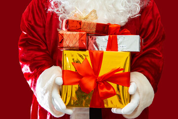 Santa Claus hands holding Christmas presents.