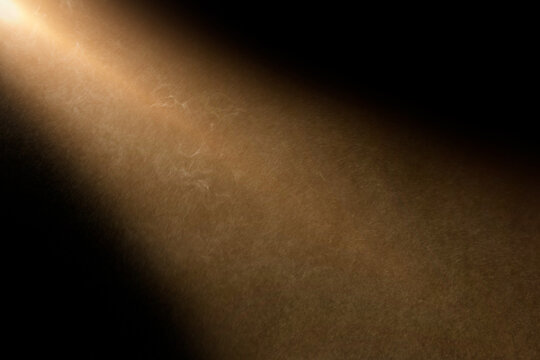 orange spotlight effect on stage or crepuscular rays or gods rays with particles  isolated on black background	