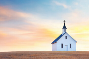 Fototapeta premium A small white church with a steeple and cross, set on an open field under a vibrant sunrise sky, symbolizing faith, peace, and spirituality.