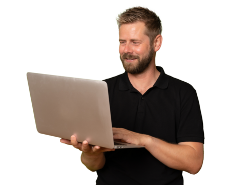 Young handsome man isolated over transparent background using his laptop computer working. Copy space for text.